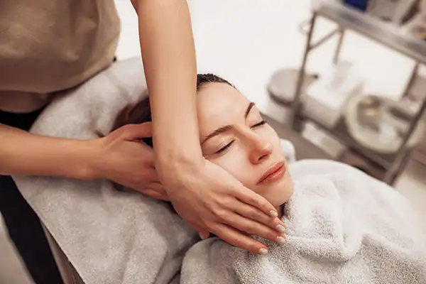 Woman having a face and body massage