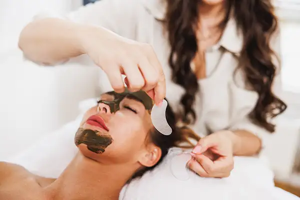 Woman getting a facial mask treatment