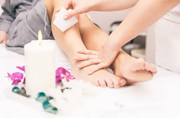 Woman getting her legs waxed at a beauty salon