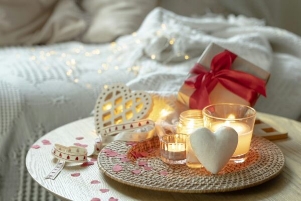 Home composition for Valentine's Day with candles in the interior of the room.
